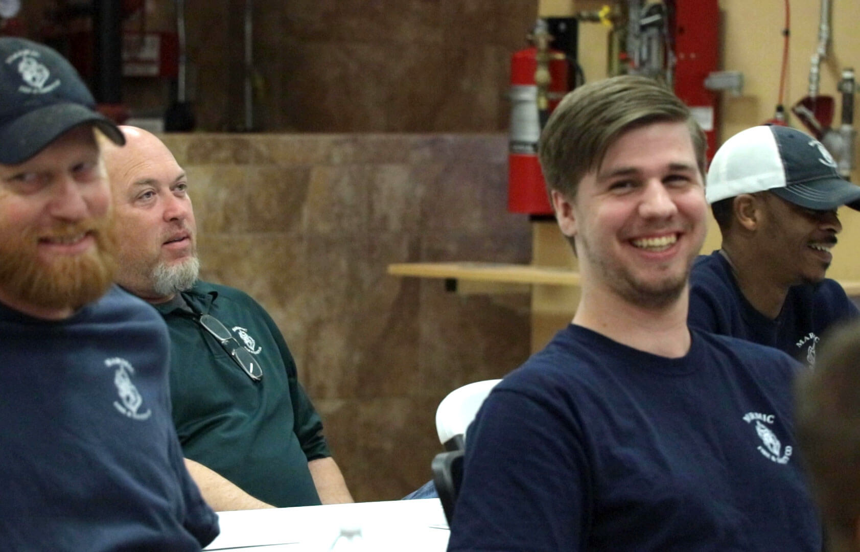 Marmic fire staff smiling in a meeting