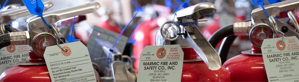 Red fire extinguishers with Marmic Fire and Safety label on it