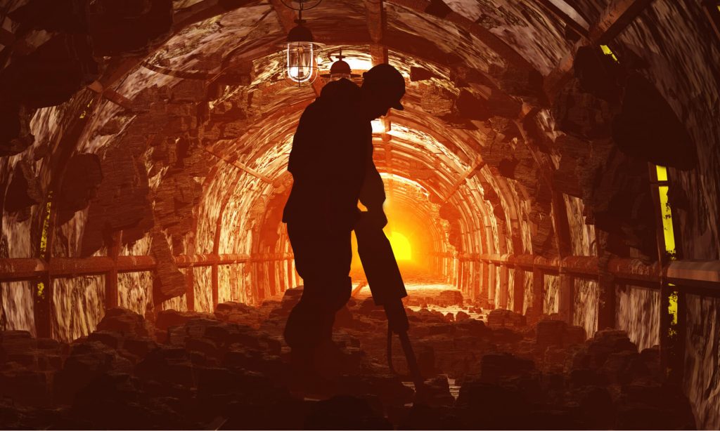 Man working in a mine with a jackhammer