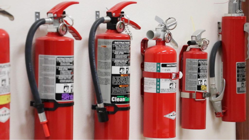 Red fire extinguishers on a wall
