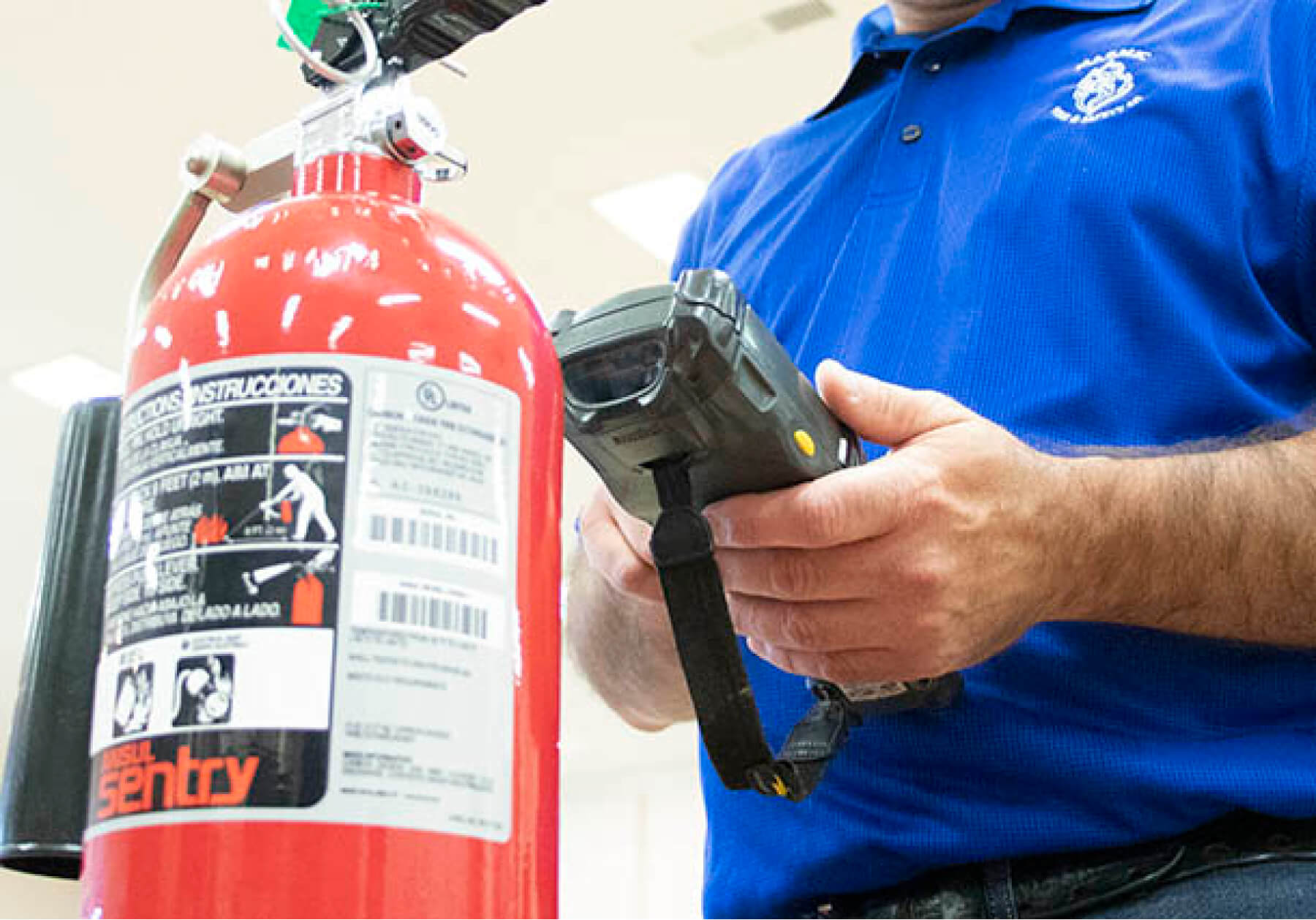Marmic fire staffer examining a fire extinguisher