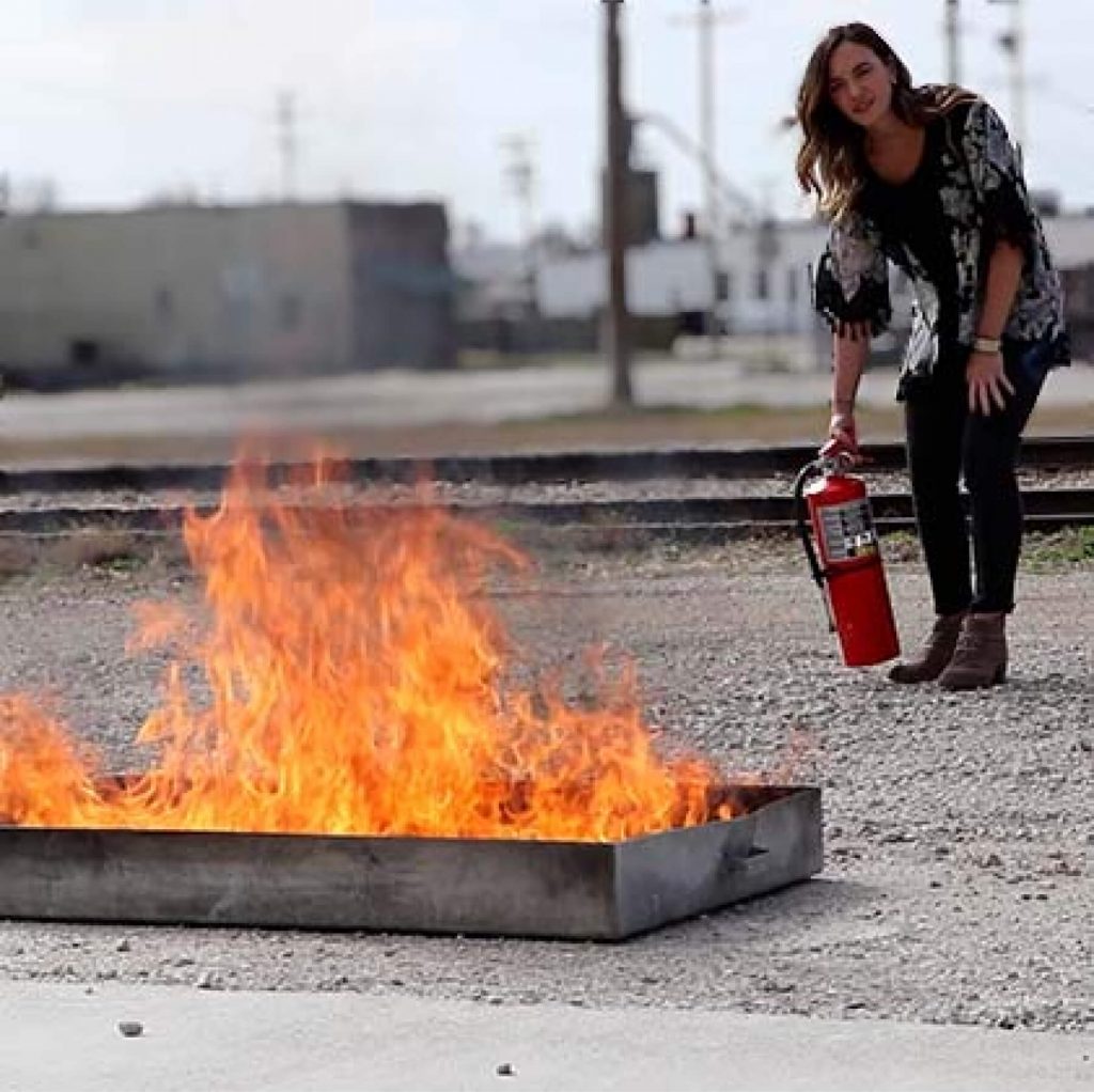 Woman undergoing fire extinguisher training